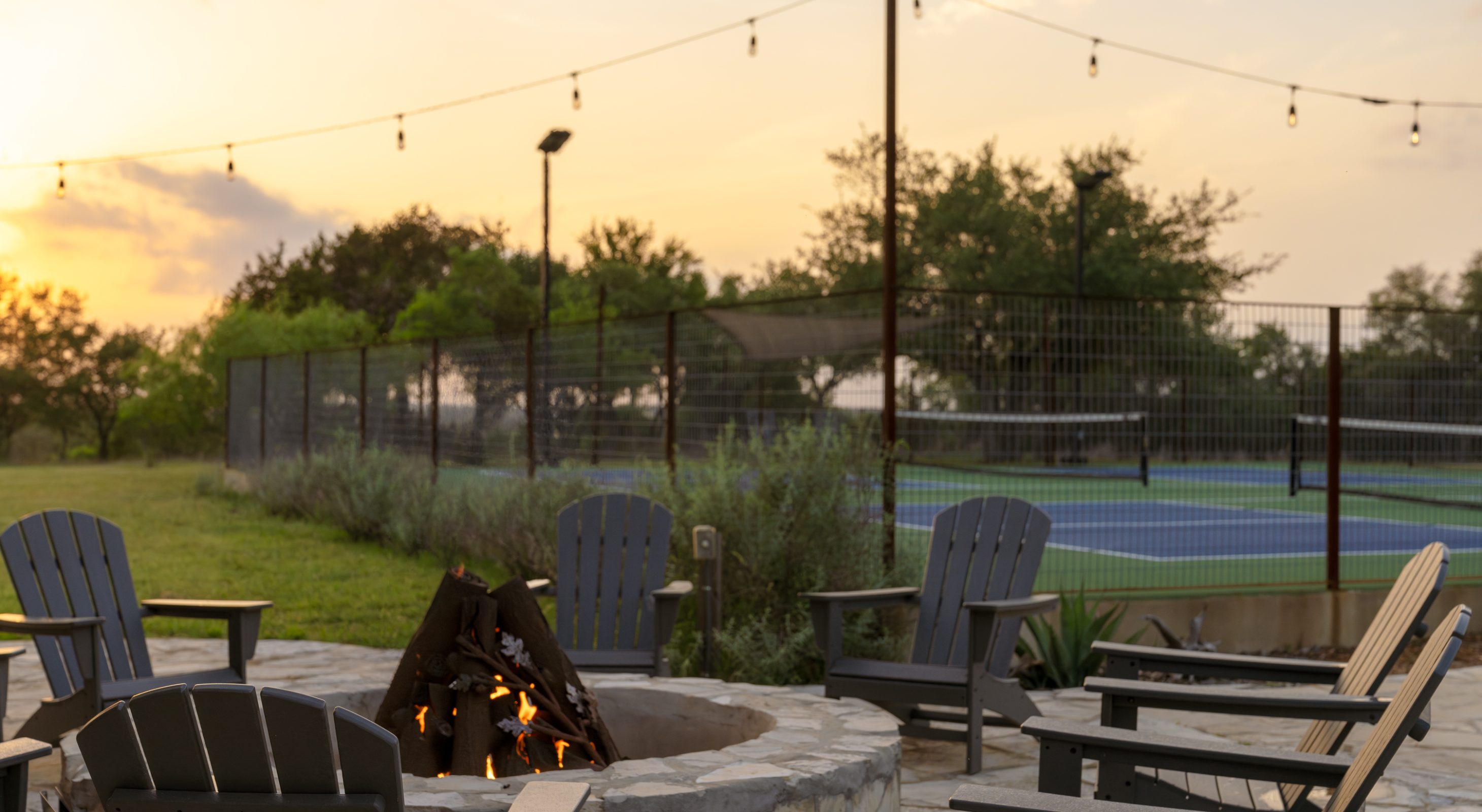 Firepit and Pickleball courts at sunset at our inn near austin, tx